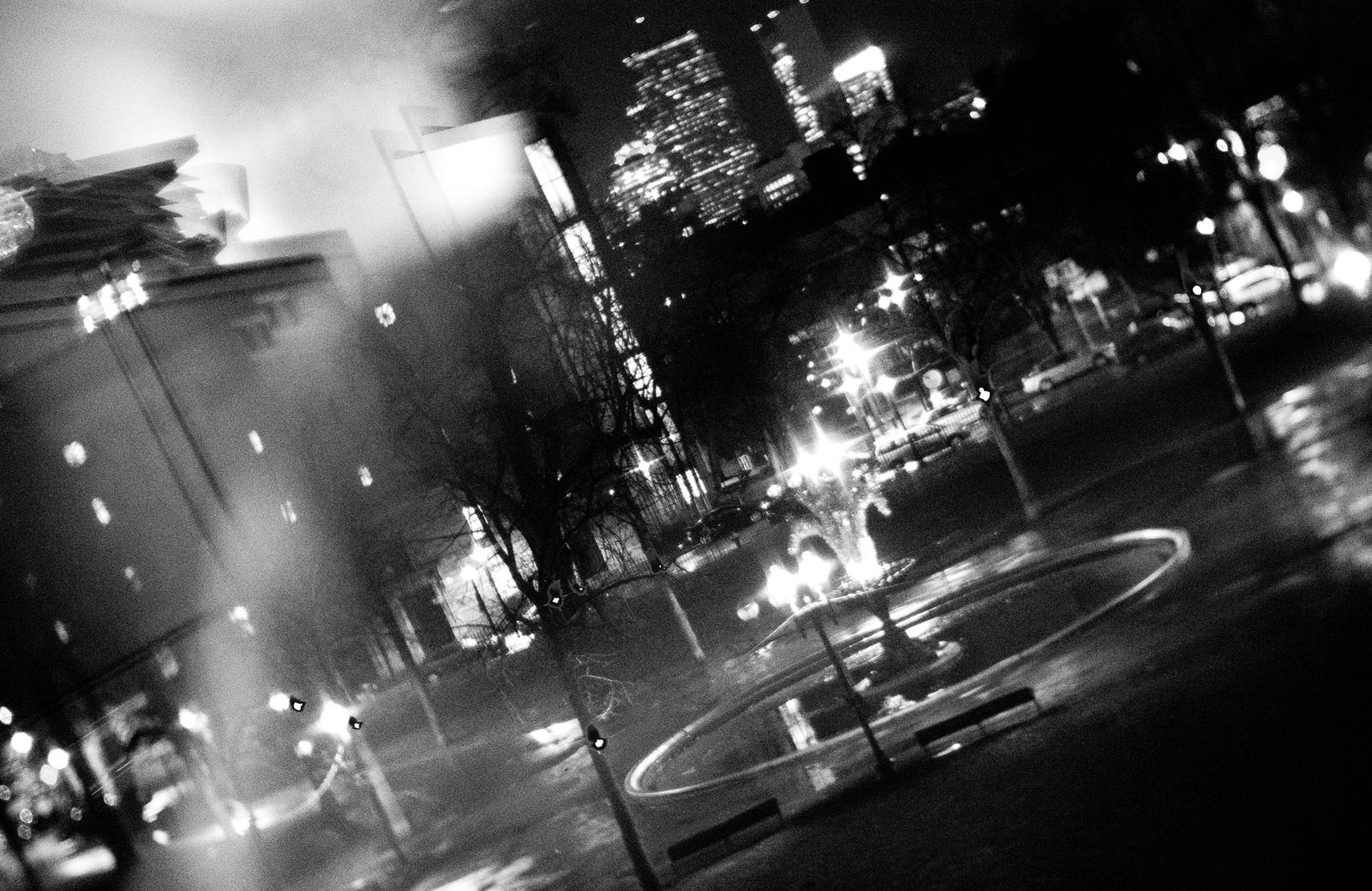 View of Blackstone Square at night from Sametz Blackstone Associates in black and white