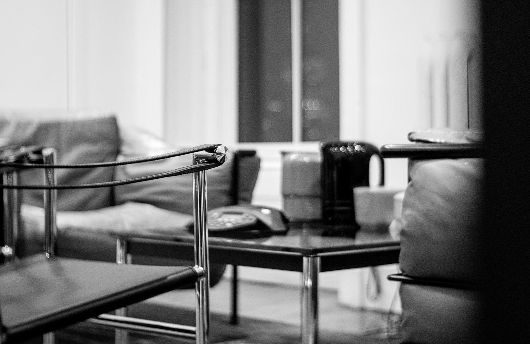 Table and chairs in Roger Sametz's office in black and white